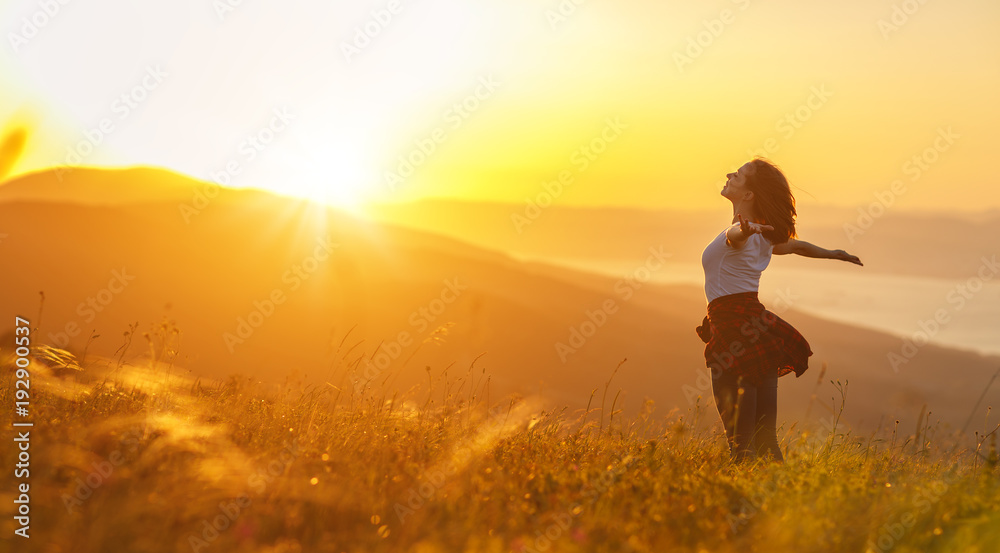 Happy woman on sunset in nature iwith open hands Happy woman on sunset in nature iwith open hands
