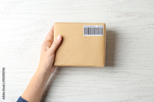 Woman with parcel box on wo...