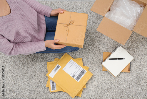 Woman preparing parcels for...