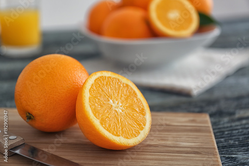 Juicy ripe oranges on wooden board