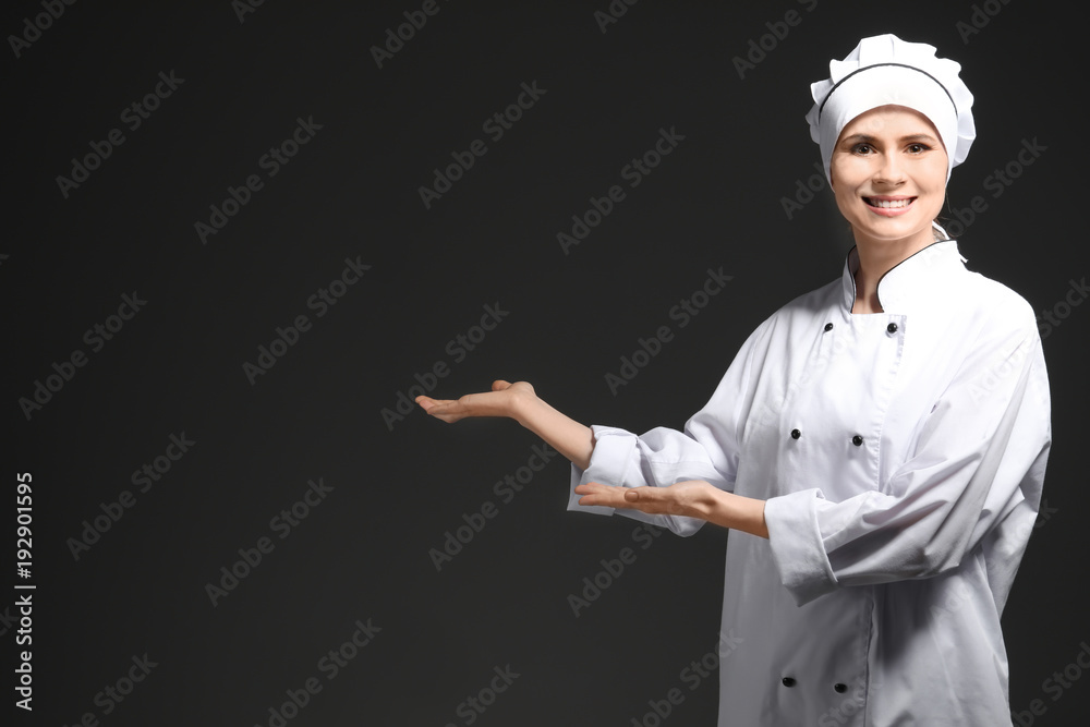 Female chef in uniform on black background Female chef in uniform on black background