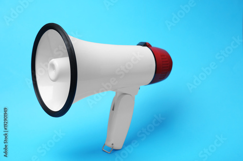 Electronic megaphone on color background