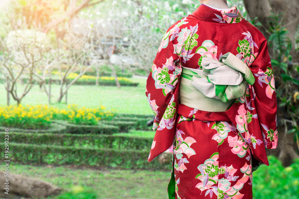 Woman wearing Kimono traditional Japan walking at public park.