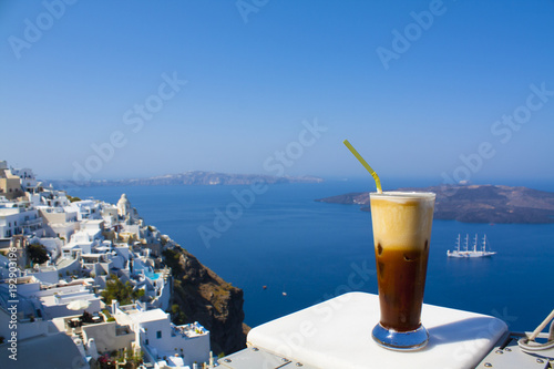 Greece Santorini island in Cyclades, coffee espresso freddo with wide sea of caldera in greek caffe