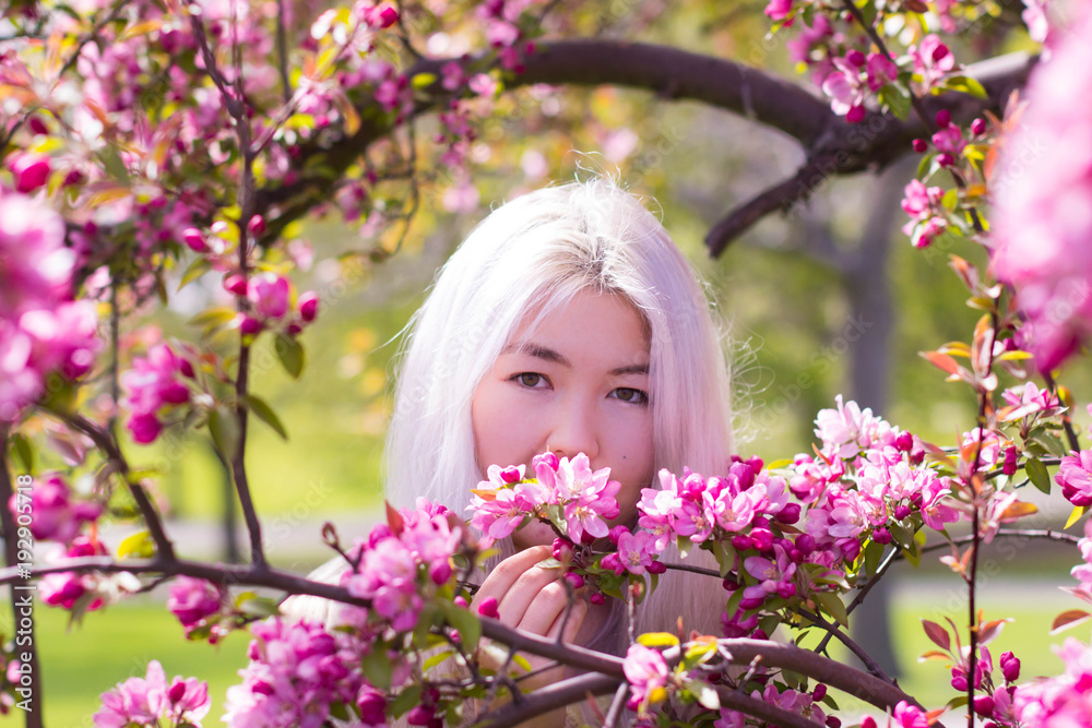 Gorgeous Kazakh lady and blossoming tree