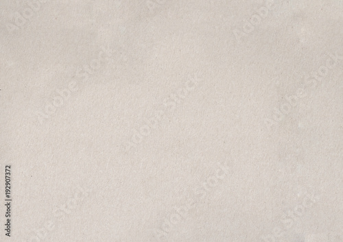 texture of light coloured kraft paper sheet with small soft brown grain dust