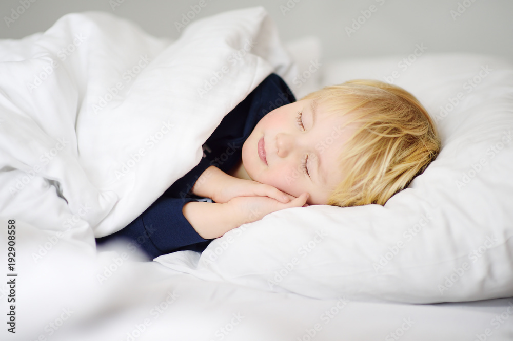 Cute little boy sleeping. Tired child taking a nap in parent's bed. Cute little boy sleeping. Tired child taking a nap in parent's bed.