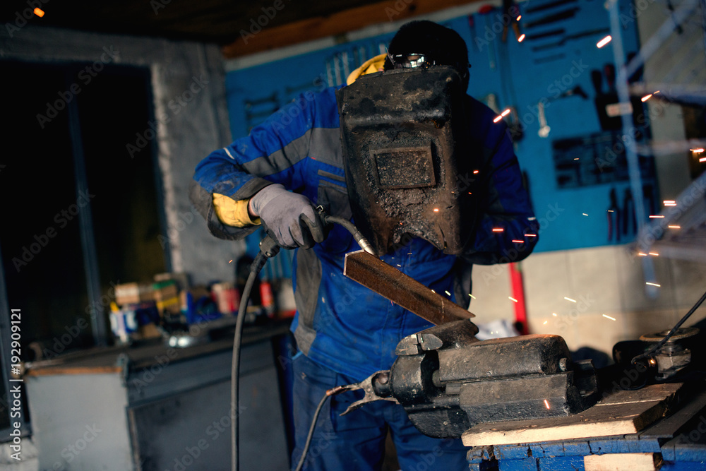 Welder with mask and torch Welder with mask and torch