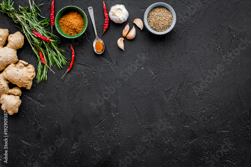 Gastronomy, culinary. Secrets of tasty dishes. Seasoning and spices. Rosemary, ginger, chili pepper on black background top view copy space
