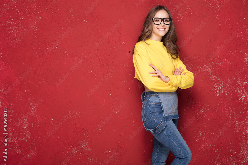 Happy girl smiling, standing on red background. Happy girl smiling, standing on red background.