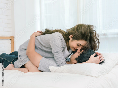 Happy Asian Lover kissing and hugging on the bed in bedroom at home, Couple and life style concept,