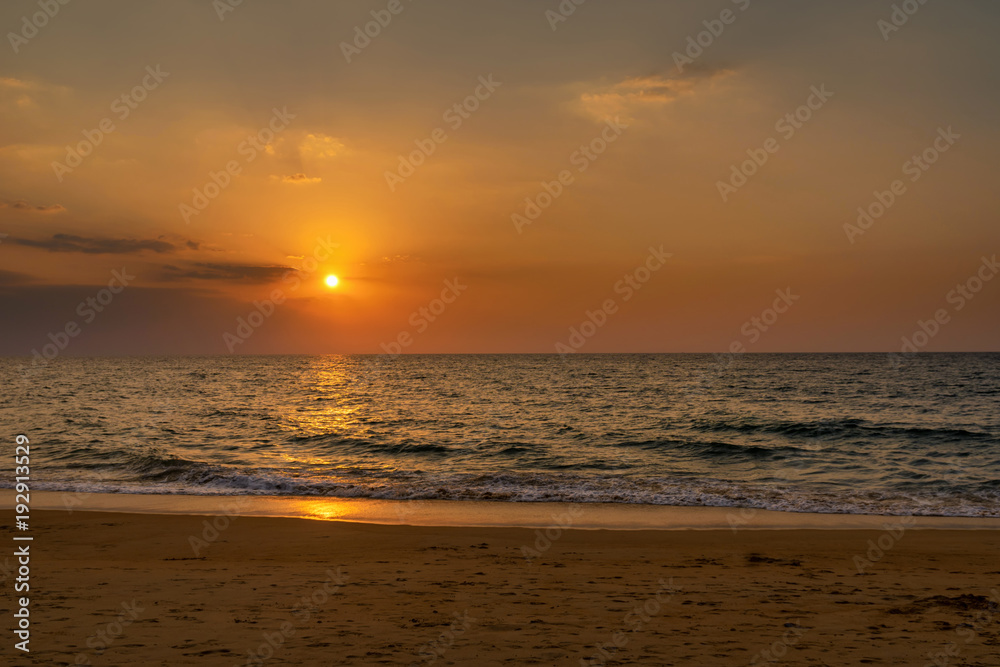 Beautiful scene of sunset with cloudscape over the sea beach
