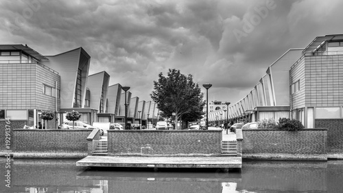 Modern street row houses and waterfront terrace in b & w photo