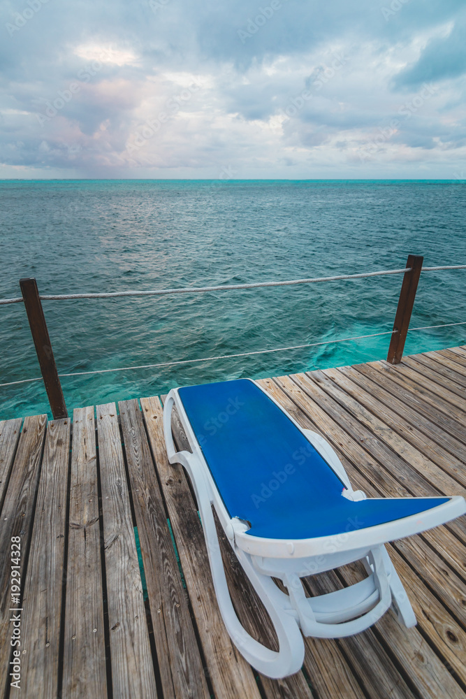 Wooden Pier and Long Blue Chairs with Nobody Wooden Pier and Long Blue Chairs with Nobody