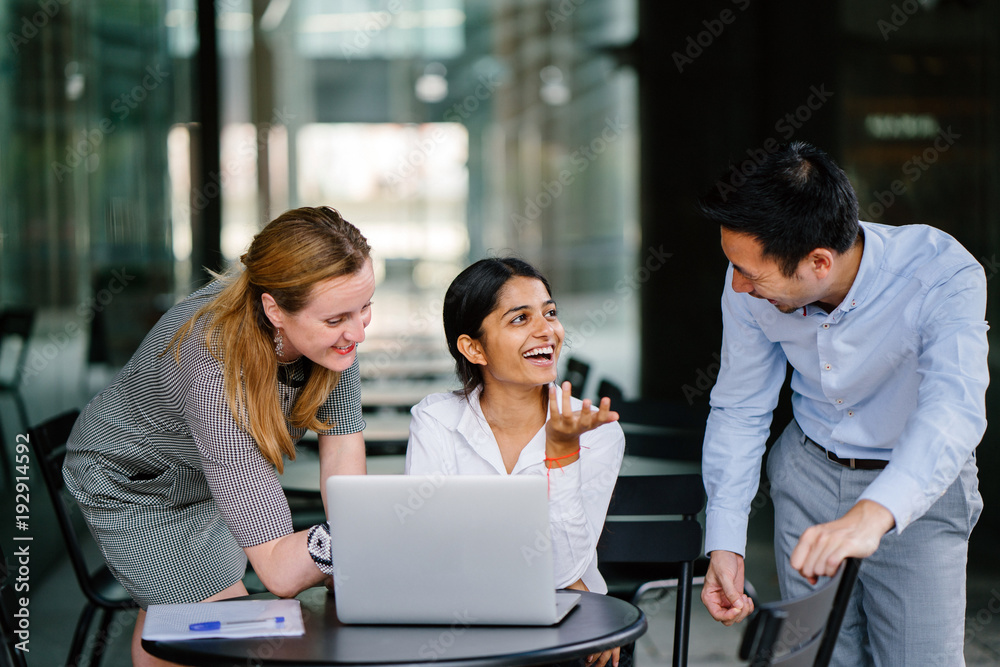 An image of meeting between a diverse group of professionals working on a new project as one team. They are using a laptop for their reference and they are all wearing professional outfits. An image of meeting between a diverse group of professionals working on a new project as one team. They are using a laptop for their reference and they are all wearing professional outfits.