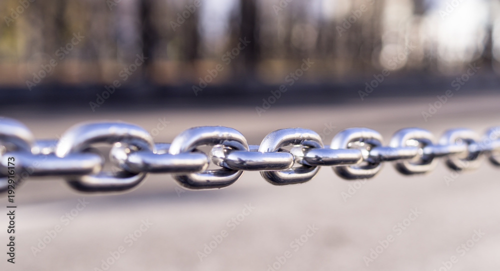 Obraz premium shiny steel chain city background. decoration, boarder.