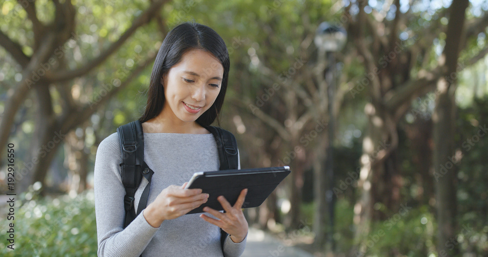 Young Woman use of tablet computer at outdoor Young Woman use of tablet computer at outdoor