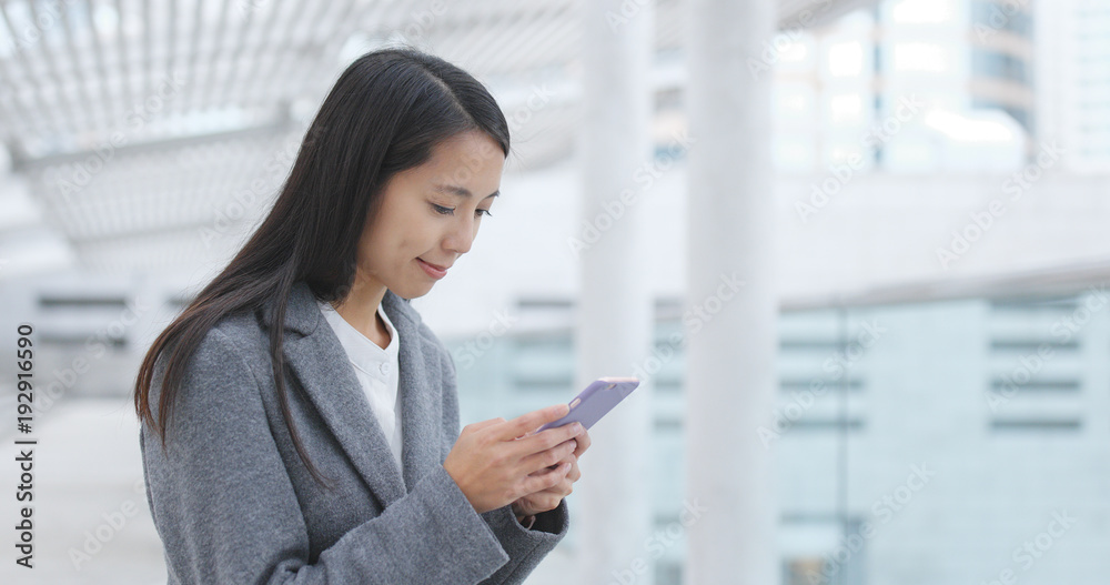 Woman use of mobile phone in city Woman use of mobile phone in city