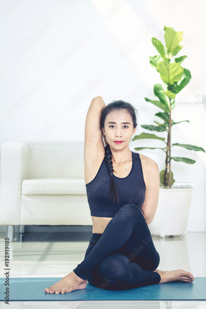 Beautiful asian sports woman performs the exercises at home .Yoga Beautiful asian sports woman performs the exercises at home .Yoga