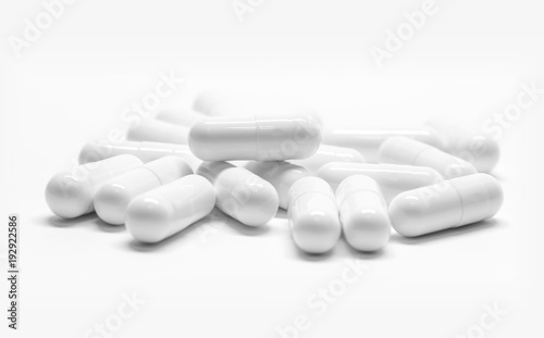 White medicine capsules on white background