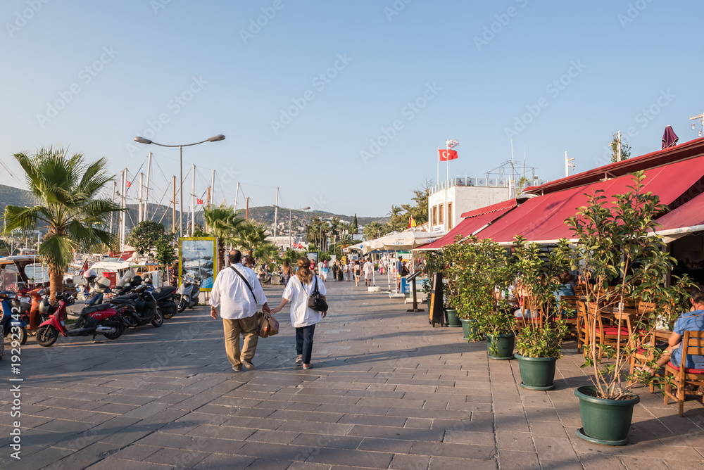 people walk along shore in Bodrum, Turkey
