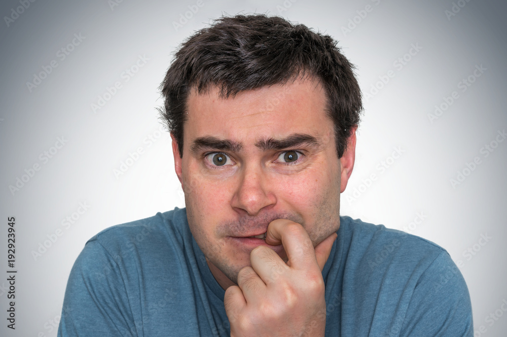 Nervous man biting his nails - nervous breakdown Nervous man biting his nails - nervous breakdown