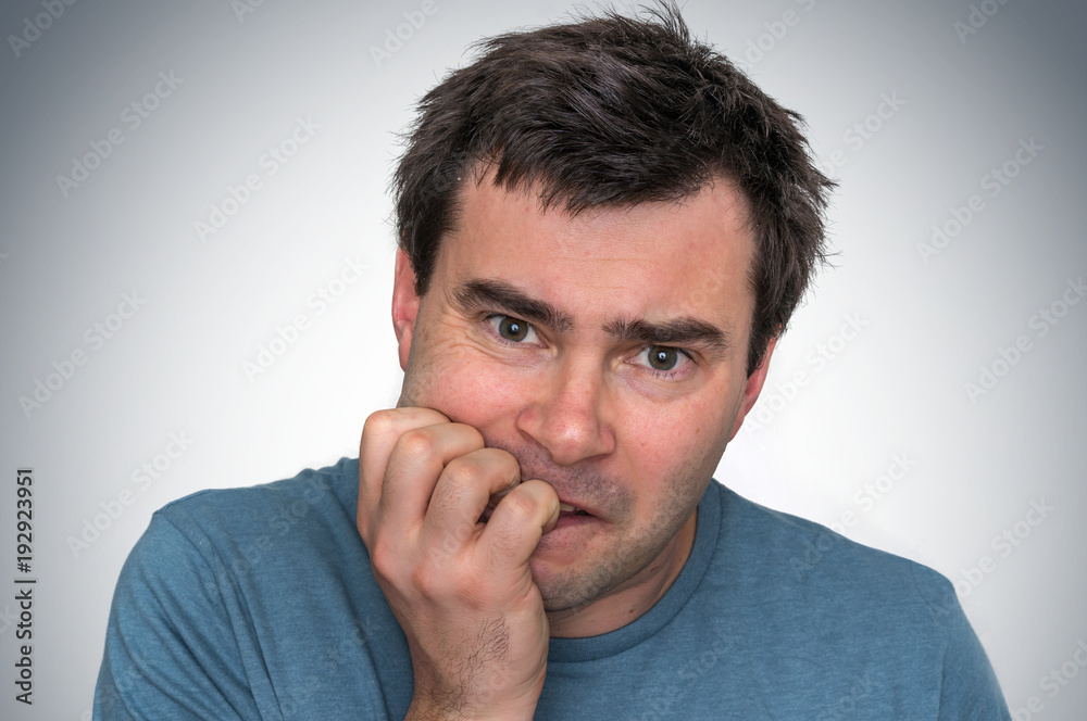 Nervous man biting his nails - nervous breakdown