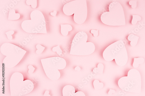 Valentine day background of many different paper hearts on pink soft background. © finepoints
