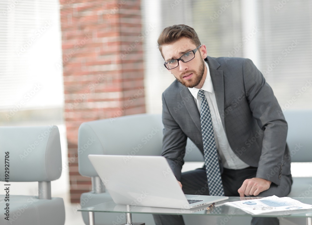 Portrait of a modern businessman sitting at his desk. Portrait of a modern businessman sitting at his desk.