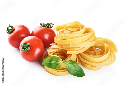 Raw tagliatelle pasta, cherry tomatoes and basil isolated on white background.
