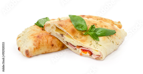 Tableau sur toile One whole and half of baked calzone with basil twigs