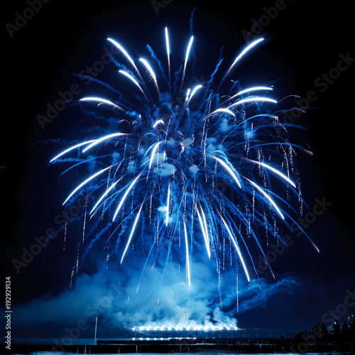 Beautiful blue fireworks on the black sky background.