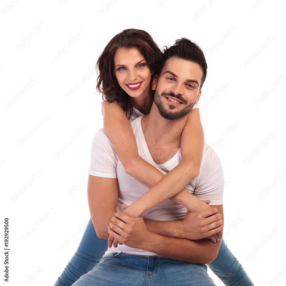 casual woman behind her seated man smiling casual woman behind her seated man smiling