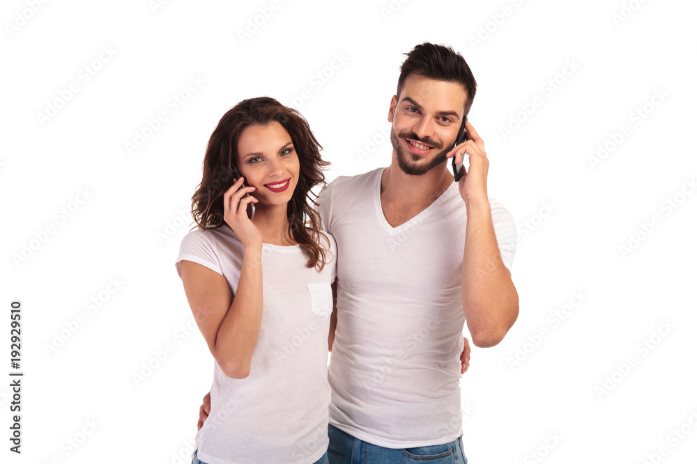 embraced casual couple talking on the phone embraced casual couple talking on the phone