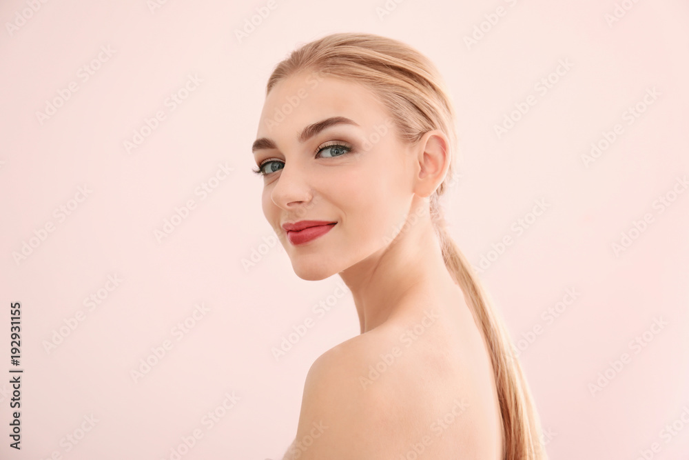 Portrait of beautiful young woman with clear skin on light background Portrait of beautiful young woman with clear skin on light background