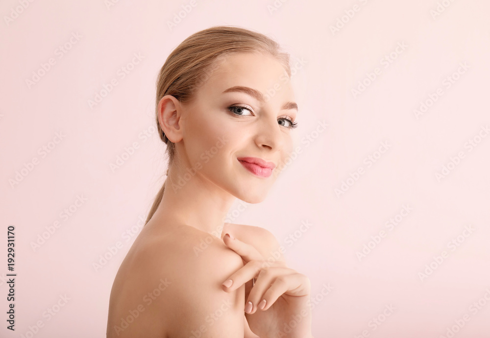 Portrait of beautiful young woman with clear skin on light background Portrait of beautiful young woman with clear skin on light background