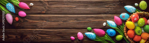 Easter Eggs and Decorative Tulips on Dark Wooden Background