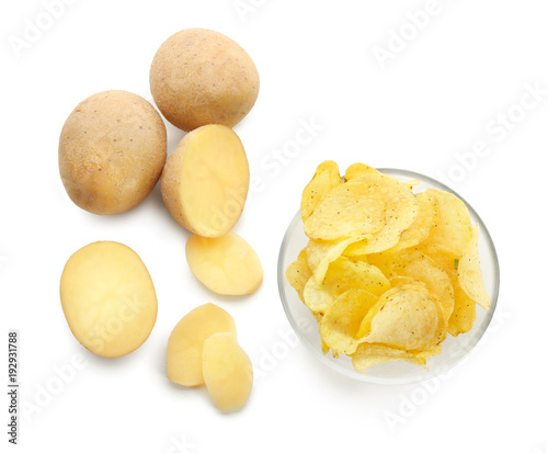 Bowl with crispy chips and raw potato on white background