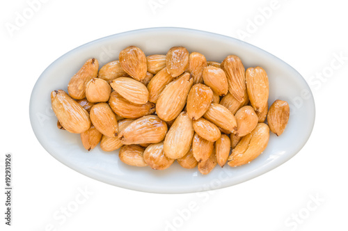 Fried almonds. Typical Spanish appetizer. We put a pan on the fire and we take oil, it should be sunflower or soft olive. We toss the almonds moving them continuously. White isolated.