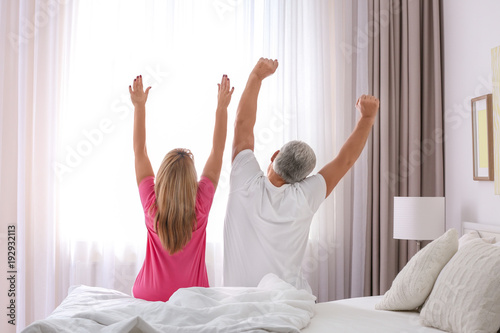 Mature couple stretching on...