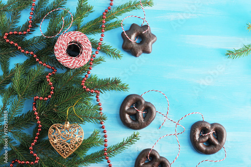 Fotografie A fur-tree branch is decorated with gingerbread in chocolate