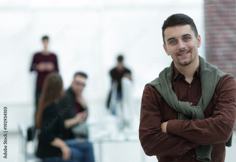 confident young man in the background of the office. confident young man in the background of the office.