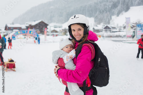 Young mother and her child, skiing in Austrian Alps