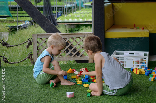 Wallpaper Mural two little brothers play together with educational toys. Outdoor playground. Thailand Torontodigital.ca