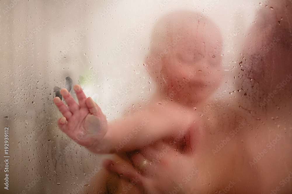 Father and baby boy in shower, drops of water Father and baby boy in shower, drops of water