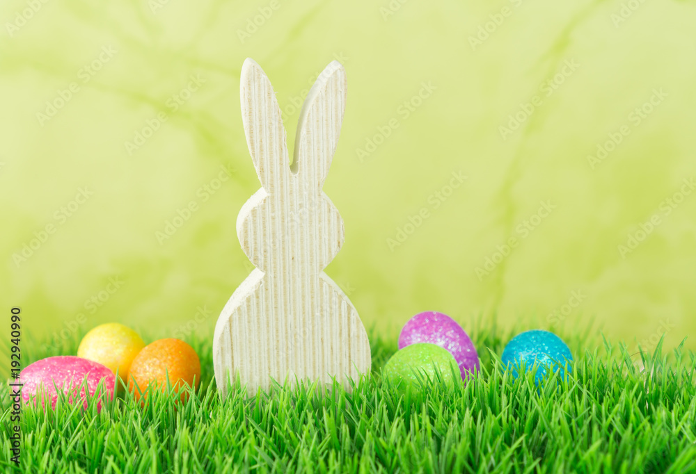 Easter bunny with Easter eggs in the meadow