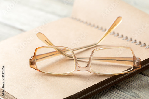 notepad and eyeglasses on the table