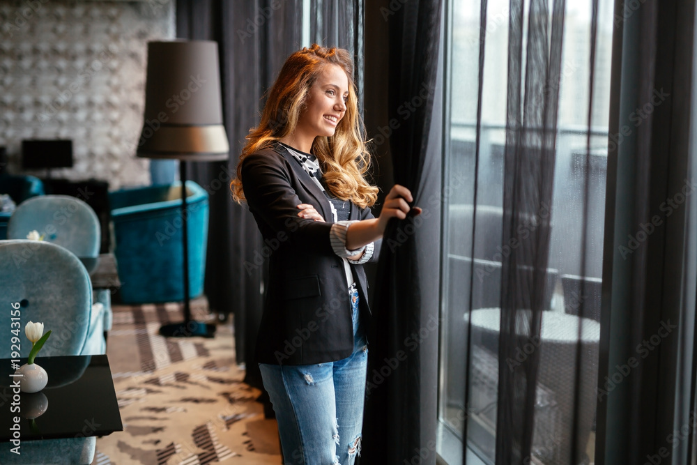 Stunning blonde looking through window Stunning blonde looking through window