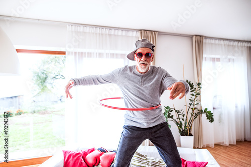 Senior man having fun at home. photo