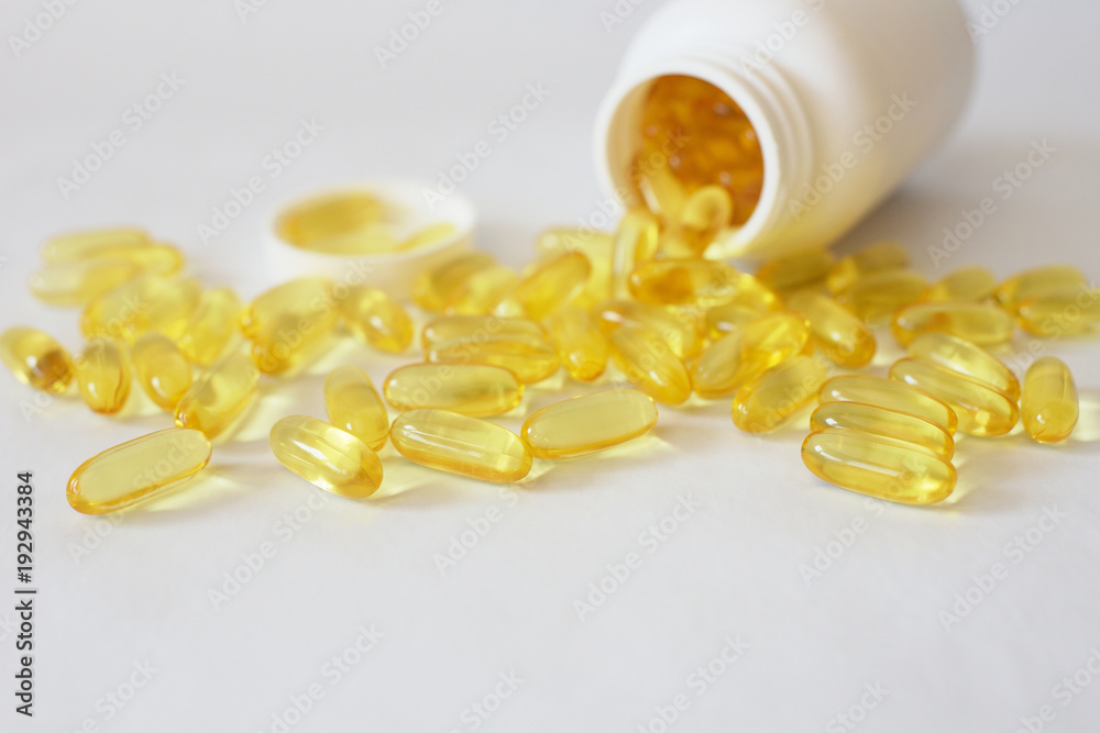 Capsules of cod-liver oil in a white jar. Omega 3
Capsules of cod-liver oil in a white jar. Omega 3